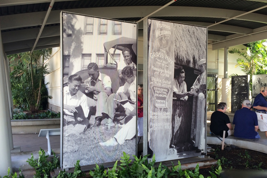 Custom banner display featuring historical black-and-white photographs of people engaging with Hawaiian culture and activities, emphasizing event branding and visual storytelling for 858 Graphics Inc.