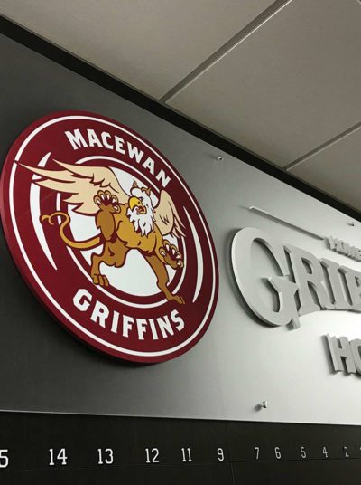 Custom metal sign featuring the Macewan Griffins logo, showcasing strength and durability in branding for businesses in Los Angeles.