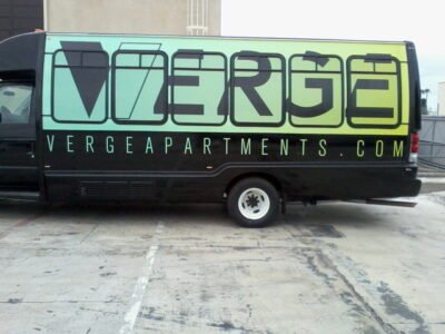Custom auto window decal on a van featuring the logo and website of Verge Apartments, promoting visibility for local businesses in Los Angeles, California.