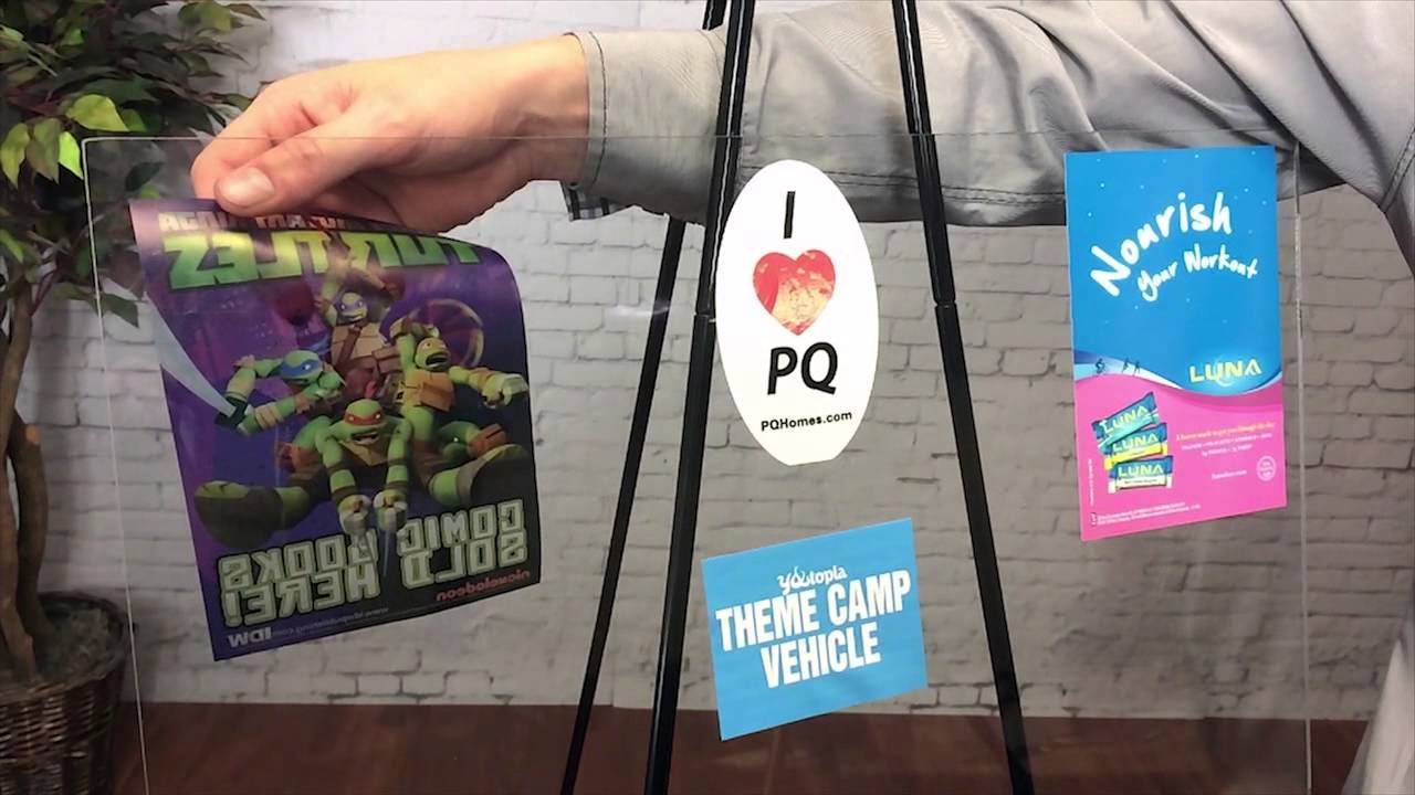 Printed event materials including brochures and sell sheets arranged for a trade show display