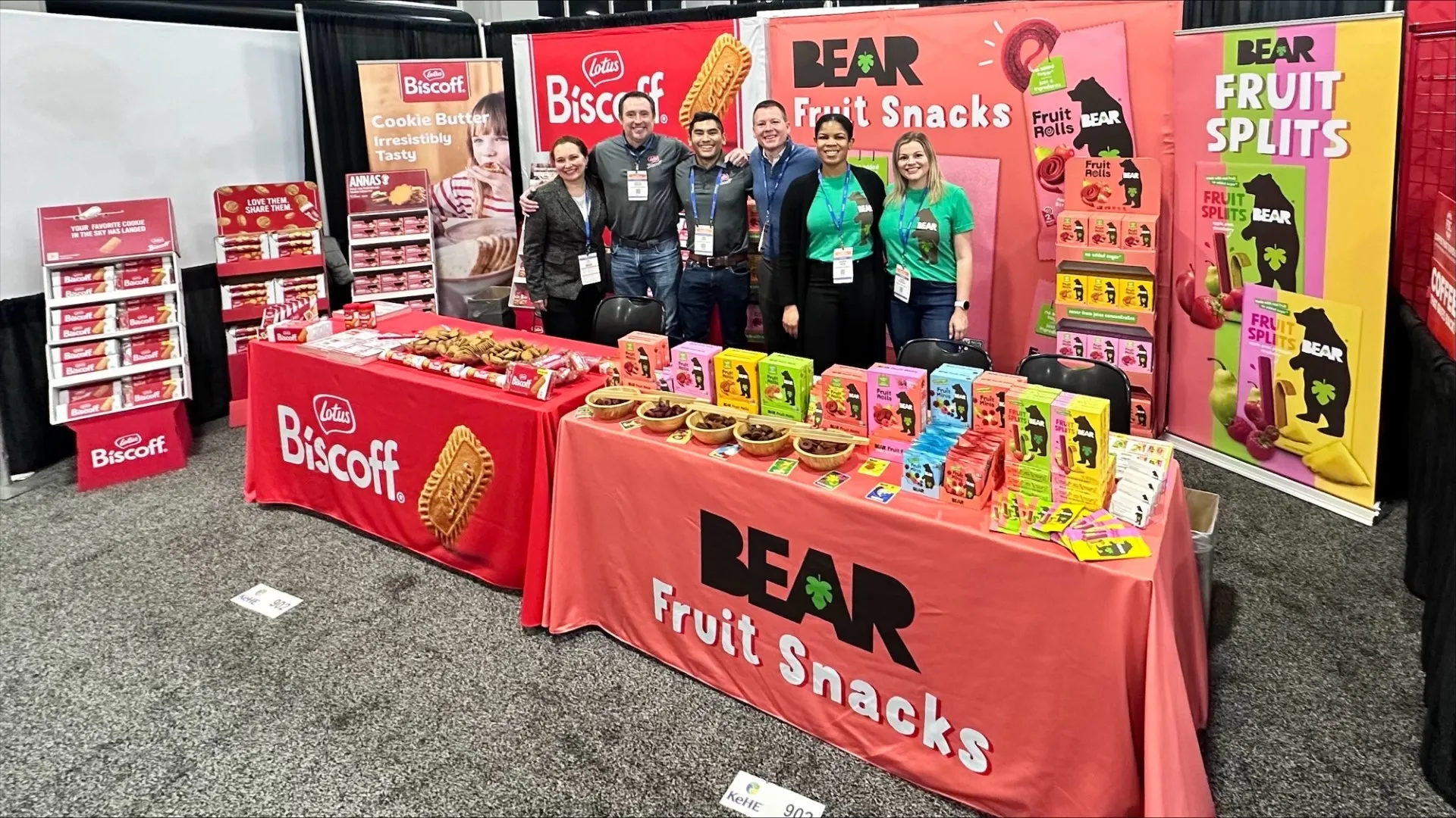 Engaged trade show team interacting warmly with attendees